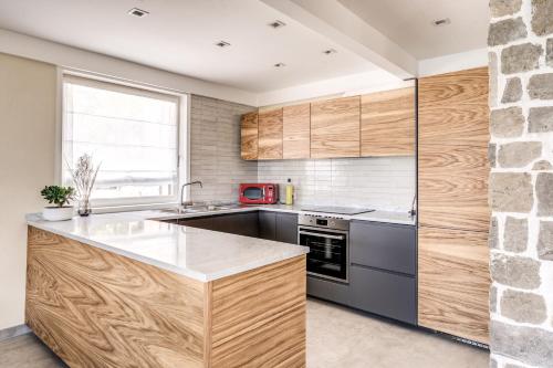 a kitchen with wooden cabinets and a stone wall at Maison Annie - Mental Wellness Retreats in Sorrento