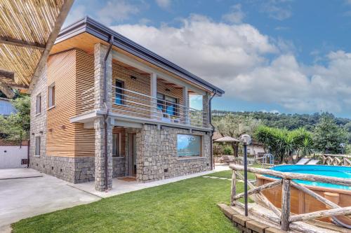 a villa with a swimming pool and a house at Maison Annie - Mental Wellness Retreats in Sorrento
