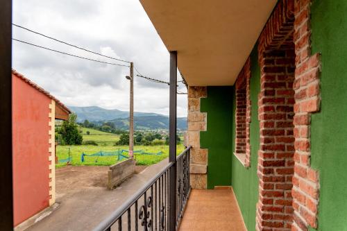 a balcony with a view of the mountains at La Casita Verde de Cabárceno in Sobarzo