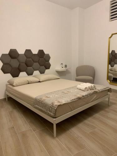 um quarto com uma cama e uma cadeira em Da Minguccio em Venosa