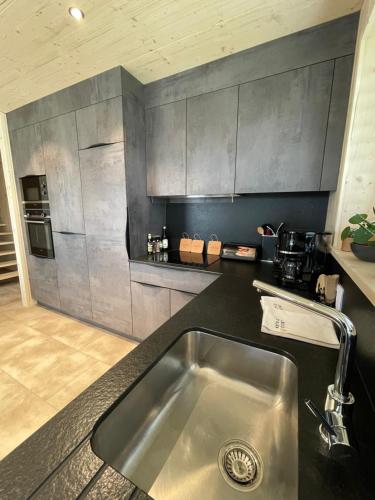 a kitchen with a sink and a counter top at Magnifique villa nature le Bois d'Aura in Luisans