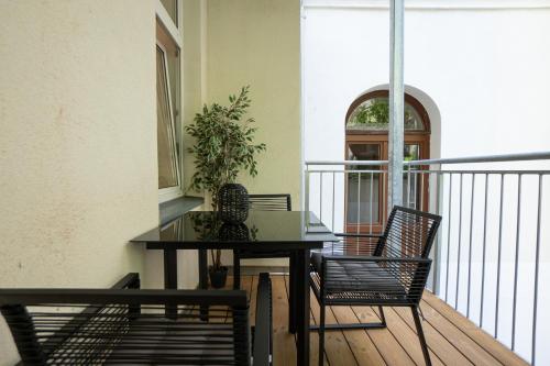 a balcony with a table and chairs on a balcony at 42 m2 central bright apartment with a terrace in Vienna