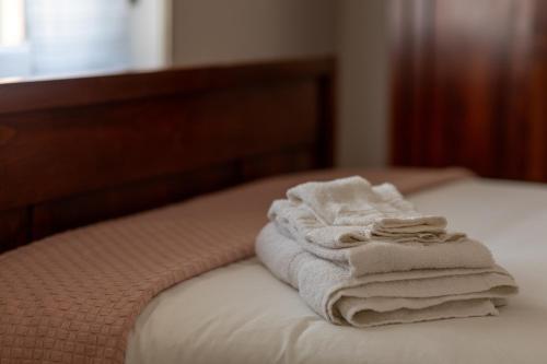 a stack of towels sitting on top of a bed at Maison Cècile Appartamento in villa. Host Marianna in Agliè