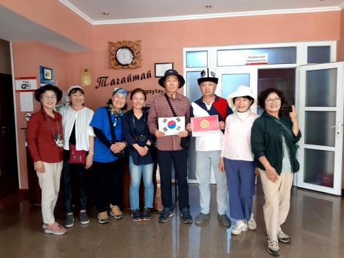a group of people posing for a picture in a room at Tagaytay Karakol Hotel in Karakol