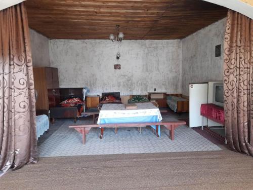 a room with a bed and a table in it at individual low-budget guest-house in Tsqaltubo