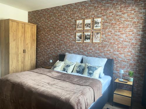 a bedroom with a brick wall and a bed at Loft Appartement in Bielefeld