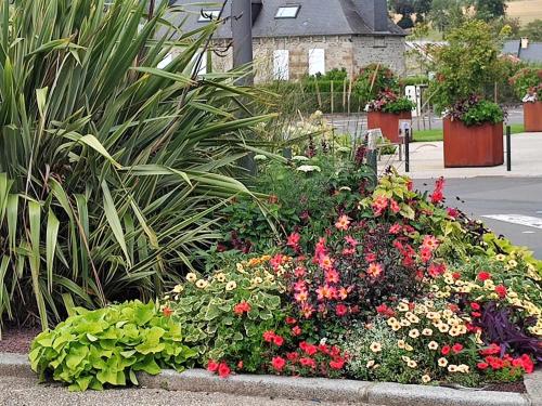 a garden with flowers and plants on a street at Perfect Gites In Normandy in Saint-Sauveur-de-Chaulieu