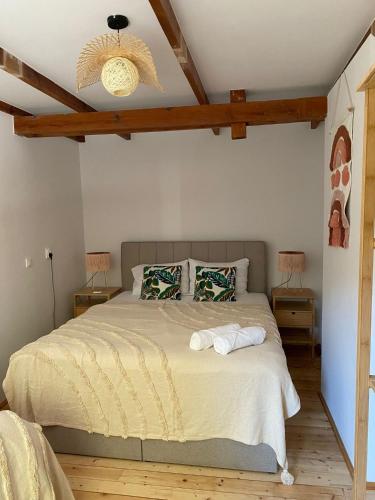 a bedroom with a large bed with two night stands at Villa Lulu Piaseczno in Piaseczno