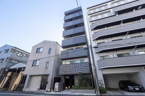 an apartment building with a car parked in front of it at aLATO Kinshicho in Tokyo