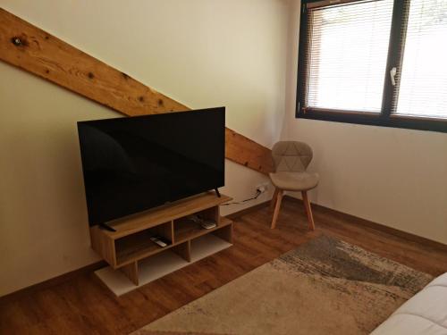a living room with a flat screen tv on a stand at La Factory in Porrentruy