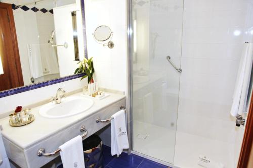 a bathroom with a sink and a shower at Augusta Eco Wellness Resort 4 Superior in Sanxenxo