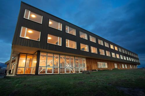 a large building with many windows at night at Best Western Patagonia in Puerto Natales