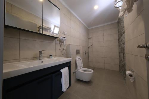a bathroom with a sink and a toilet at Premier İnn Cİty in Antalya