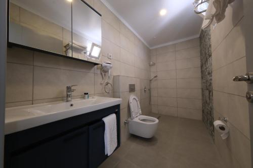 a bathroom with a sink and a toilet at Premier Inn City Antalya in Antalya