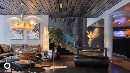 a living room with a couch and chairs at Thingholt by Center Hotels in Reykjavík