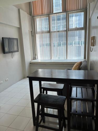 a dining room with a table and two chairs at unit 1827 Eton Emerald Loft ortigas , pasig city in Manila