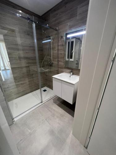 a bathroom with a shower and a sink and a toilet at St Julians 2 bedroom apartment in St. Julianʼs