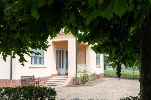 a house with a bench in front of it at Maison Cècile Appartamento in villa. Host Marianna in Agliè