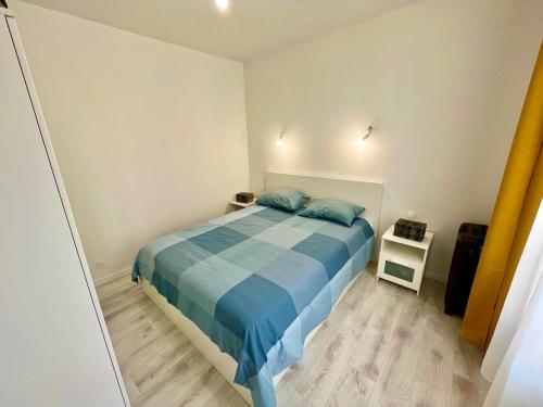 une chambre avec un lit avec des oreillers bleus dessus dans l'établissement Paris Ivry, à Ivry-sur-Seine