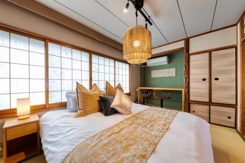 a bedroom with a large bed with pillows at Maru Taisho in Osaka