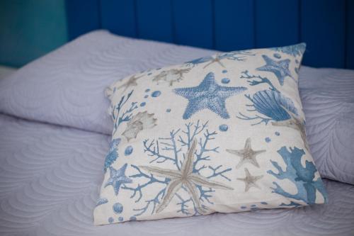 a pillow on a bed with a starfish at AFFITTACAMERE ELENA in Sanremo