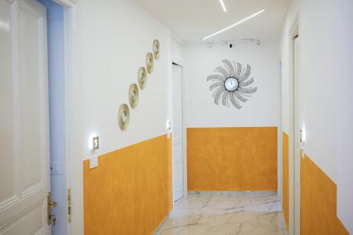 a hallway with a door and a clock on the wall at AFFITTACAMERE ELENA in Sanremo