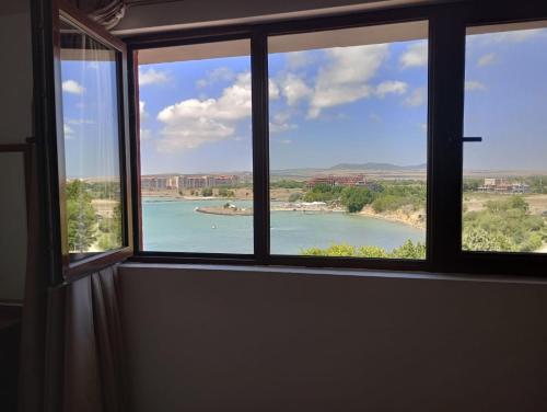 a window with a view of a body of water at Seaview Holiday - Черноморска почивка in Aheloy