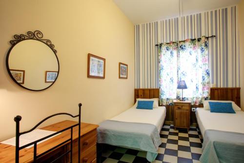 En eller flere senger på et rom på Málaga Lodge Guesthouse