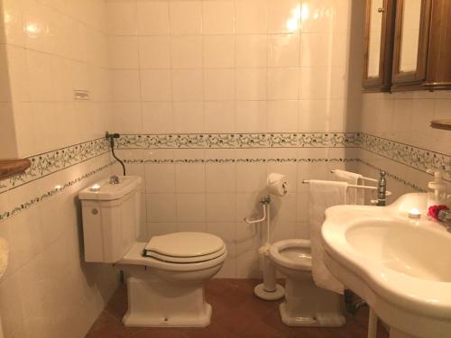 a bathroom with a toilet and a sink at Villa San Martino in Serrazzano