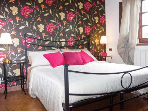 a bedroom with a bed with a floral wallpaper at Villa San Martino in Serrazzano
