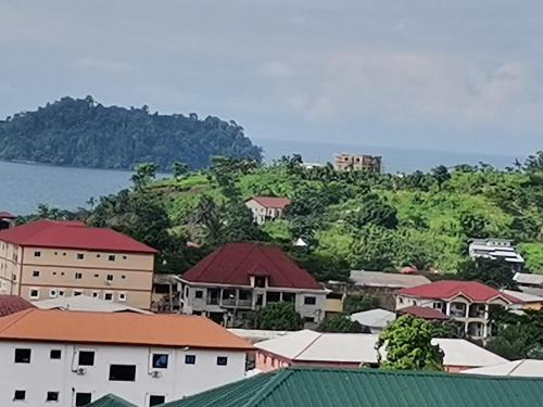 a view of a town with buildings and the water at Studio de luxe chez FOUR IN ONE Résidence in Limbe