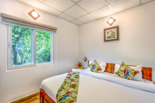 a bedroom with two beds and a window at Neer Ganga Resorts in Rishīkesh
