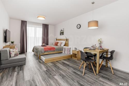 a bedroom with a bed and a desk and a chair at KORZO LIPNO 2 in Lipno nad Vltavou