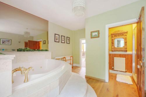 a large bathroom with a large bath tub at Brookside Manor House in Chirk