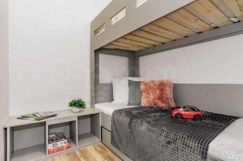 a small bedroom with a bed with a toy car on it at KORZO LIPNO 2 in Lipno nad Vltavou