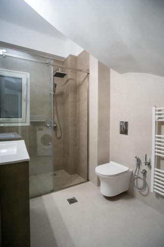 a bathroom with a shower and a toilet and a sink at EDEL Luxury Apartments in Chania