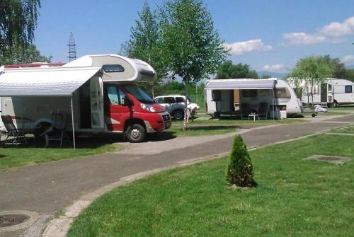 a red van parked next to a trailer and tents at Hotel Bellevue in Skopje