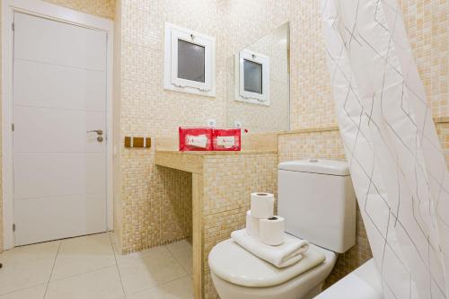 a bathroom with a toilet with two towels on it at Alcam Torrent in Barcelona