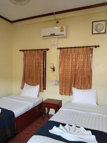 Postel nebo postele na pokoji v ubytování Thipphaphone Guesthouse