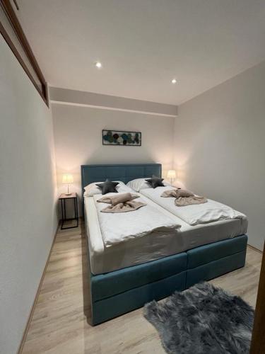 a bedroom with a large bed and two lamps at Apartmány Romantika 7 19 CHOPOK JUH Lux in Horná Lehota