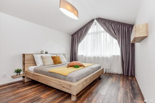 a bedroom with a bed and a window at KORZO LIPNO 2 in Lipno nad Vltavou