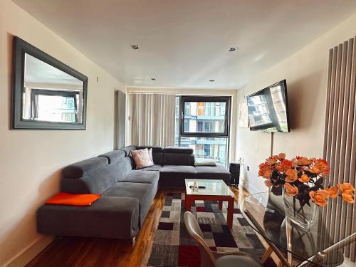 a living room with a couch and a table at Canary Wharf - Luxury Apartments in London