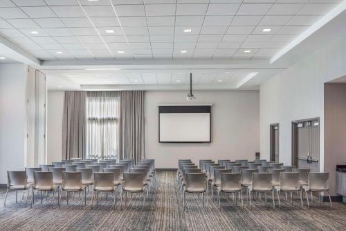 a conference room with chairs and a white screen at Embassy Suites by Hilton Atlanta Midtown in Atlanta