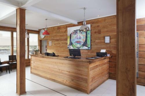 a lobby with a desk with a laptop on it at Best Western Patagonia in Puerto Natales