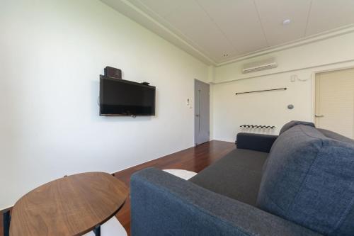 a living room with a couch and a table at Slow Pine Homestay in Sanxing