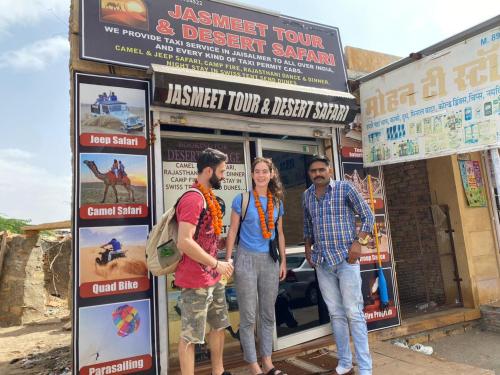 a group of three people standing in front of a store at Jasmeet hotels in Jaisalmer