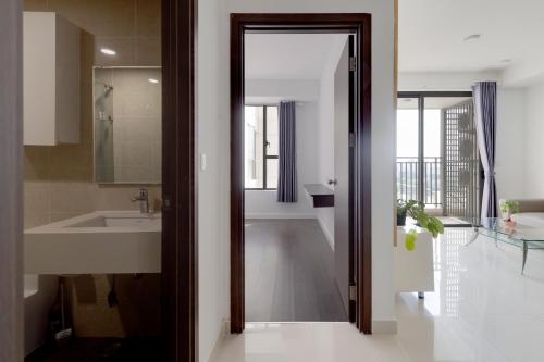 a bathroom with a sink and a mirror at Smile Home Tresor apartment - Modern comfortable in Ho Chi Minh City