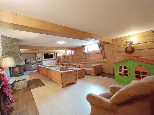 a large living room with a couch and a fireplace at Góralski Dworek in Biały Dunajec