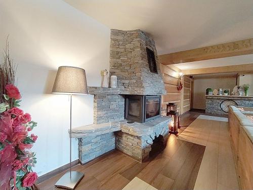 a living room with a large stone fireplace at Góralski Dworek in Biały Dunajec