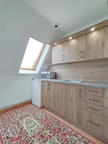 an empty kitchen with a sink and a window at Góralski Dworek in Biały Dunajec
